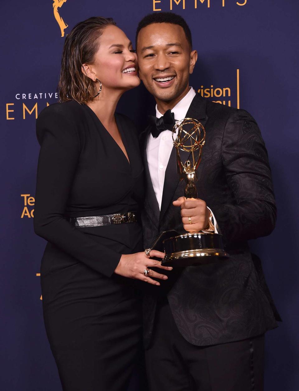 Chrissy Teigen and John Legend pose in the press room during the 2018 Creative Arts Emmys at Microsoft Theater on September 9, 2018 in Los Angeles, California