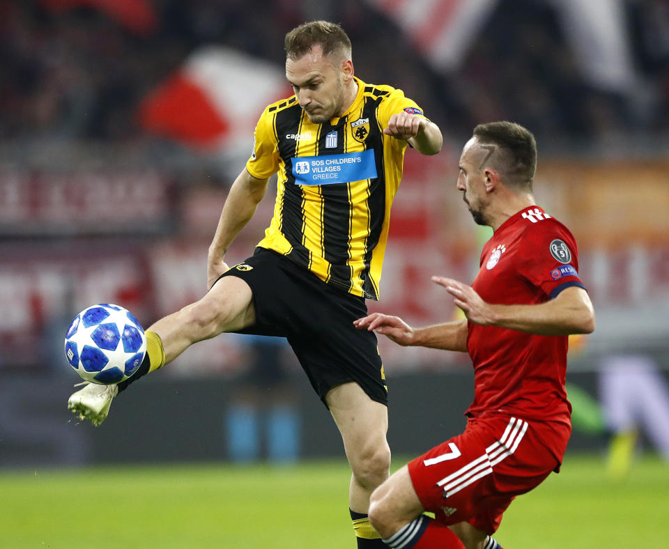 Bayern midfielder Franck Ribery, right, and AEK's Michalis Bakakis fight for the ball during the Champions League group E soccer match between FC Bayern Munich and AEK Athen in Munich, Germany, Wednesday, Nov. 7, 2018. (AP Photo/Matthias Schrader)