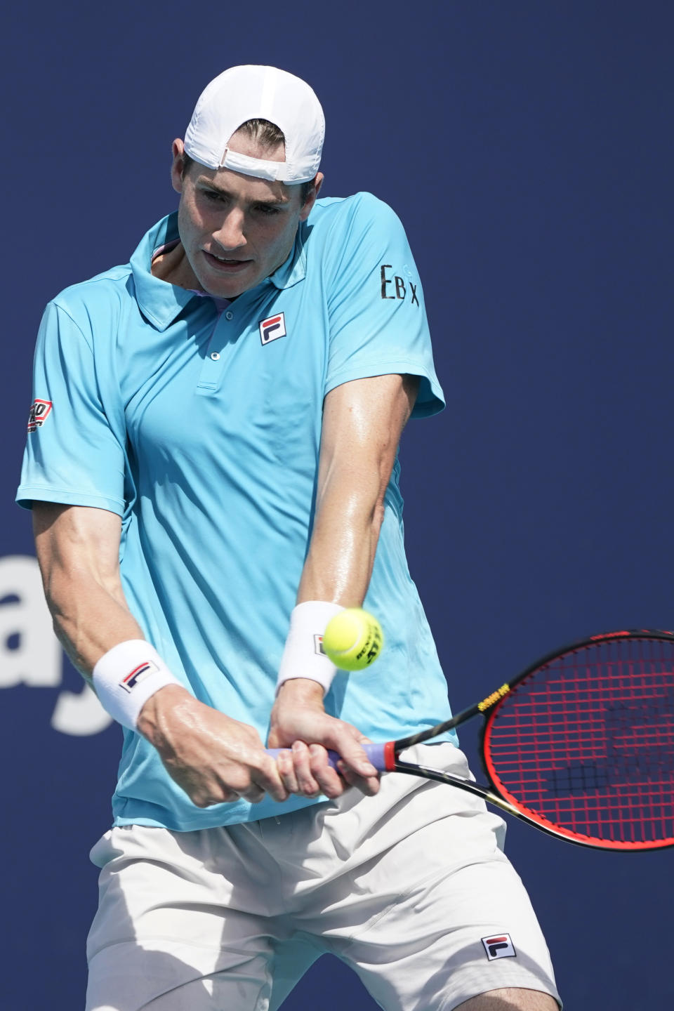 John Isner returns to Felix Auger-Aliassime of Canada, during the Miami Open tennis tournament, Sunday, March 28, 2021, in Miami Gardens, Fla. (AP Photo/Marta Lavandier)