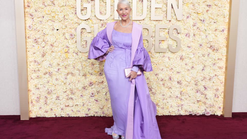 Helen Mirren looked regal in a lavender Dolce & Gabbana dress and oversized puff-sleeved opera coat, silver platforms by Sole Bliss and Harry Winston jewelry. - Jordan Strauss/Invision/AP