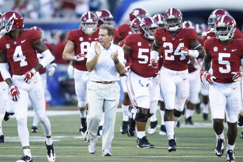 Nick Saban leads his Alabama team onto the field before a college football game. (Getty)