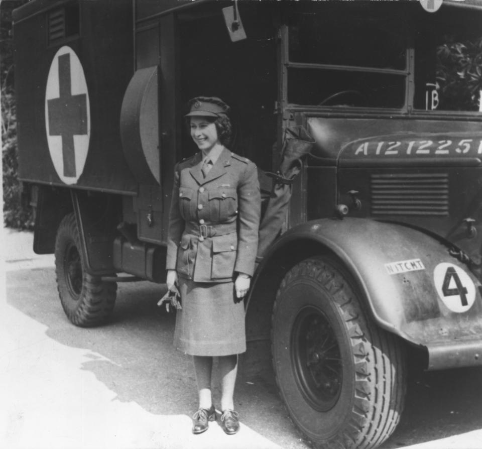 1945: Princess Elizabeth, standing by an Auxiliary Territorial Service first aid truck wearing an officer's uniform.
