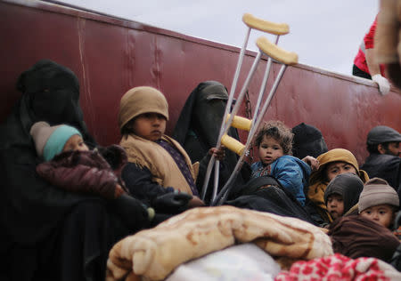 Children sit at a back of a truck near the village of Baghouz, Deir Al Zor province, Syria February 27, 2019. REUTERS/Rodi Said