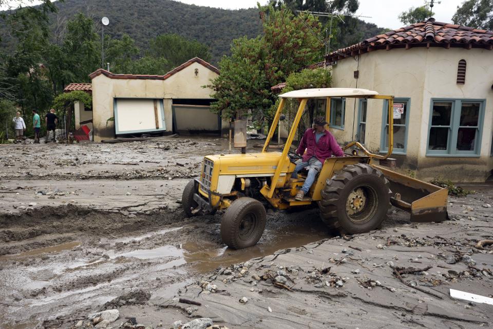 Resident Robbie Law uses a tractor to clear a neighbor’s driveway in the aftermath of Tropical Storm Hilary Monday, Aug. 21, 2023, in Yucaipa, Calif. | Marcio Jose Sanchez, Associated Press