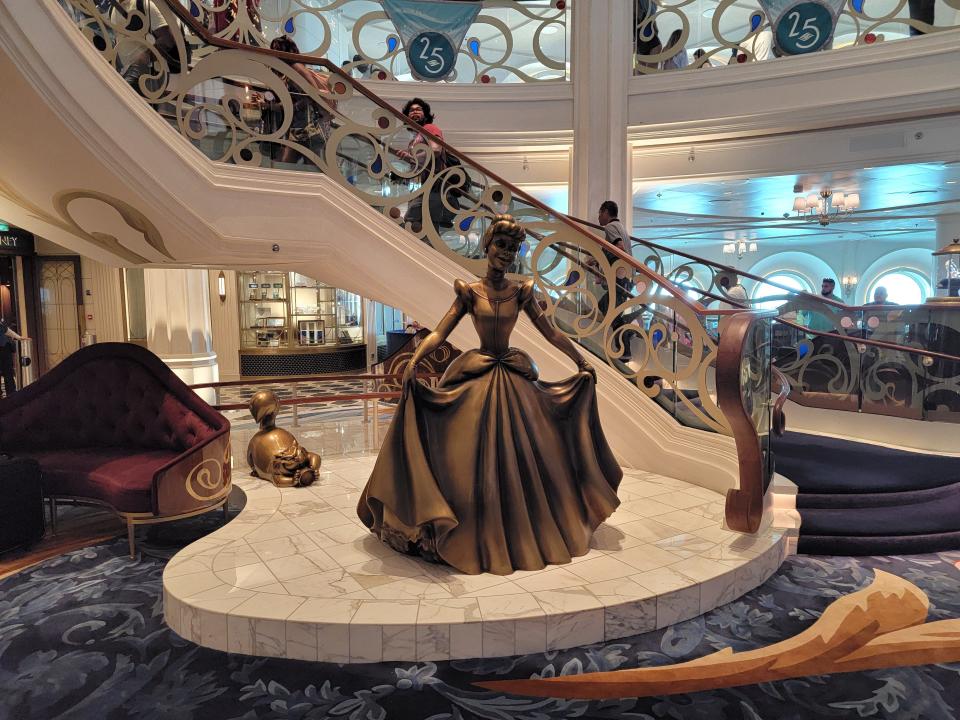 cinderella statue in the grand hall of the disney wish cruise ship