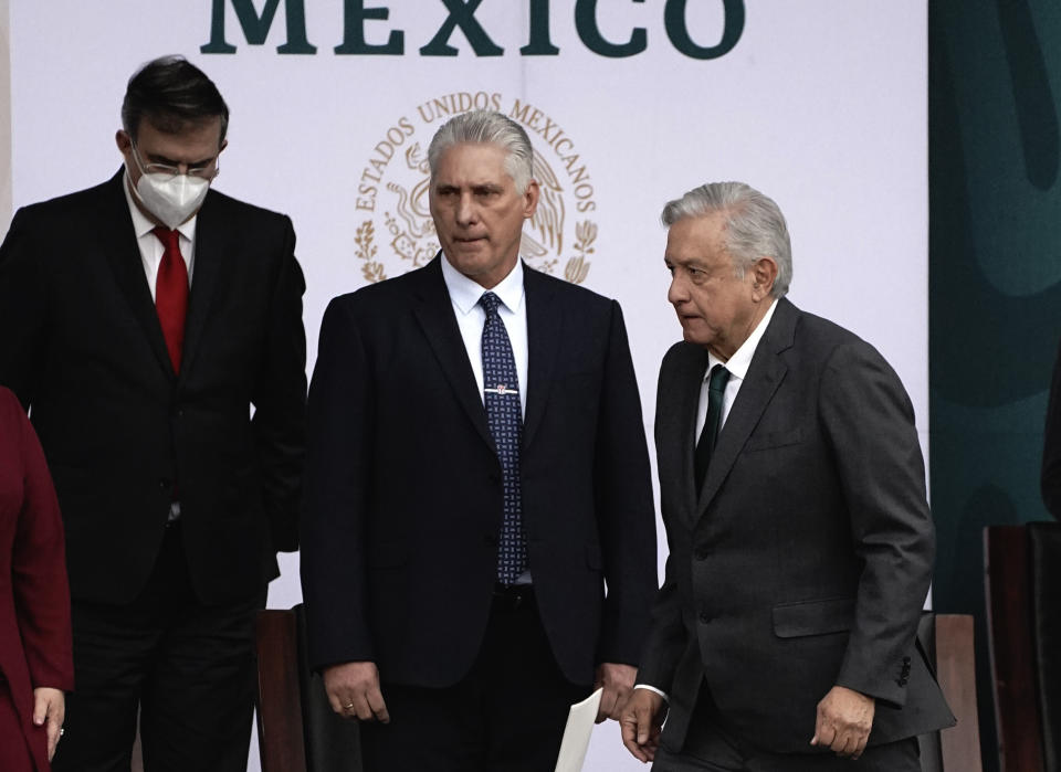 Cuba's Miguel Diaz-Canel, center, accompanies Mexico President Andres Manuel Lopez Obrador, during Independence Day celebrations in the Zocalo in Mexico City, Thursday, Sept. 16, 2021. (AP Photo/Marco Ugarte)