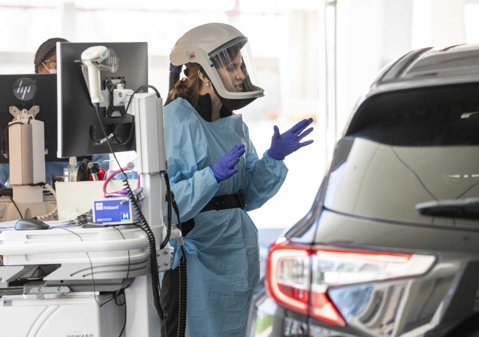 Physician assistant Jennifer Krzmarzick talks to a patient in their car after performing a swab test for COVID-19 during a trial run for an outdoor emergency triage at Mt. Carmel East hospital on the Far East Side in April 2020.