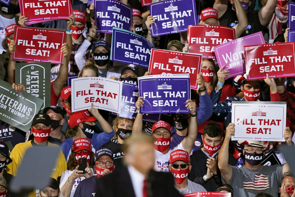 Supporters of President Donald Trump hold up signs as he speaks at a campaign rally, Monday, Sept. 21, 2020, in Swanton, Ohio. (AP Photo/Tony Dejak)