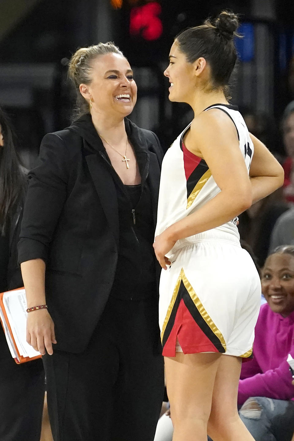 Las Vegas Aces head coach Becky Hammon, left, smiles with guard Kelsey Plum late in the second half of the WNBA Commissioner's Cup basketball game against the Chicago Sky Tuesday, July 26, 2022, in Chicago. The Aces won 93-83. (AP Photo/Charles Rex Arbogast)