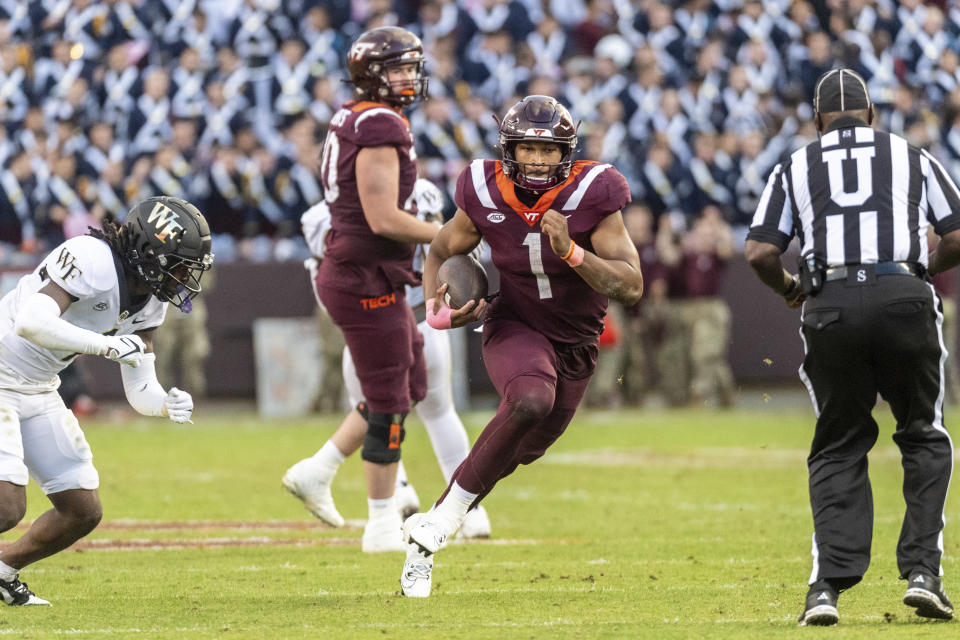 Virginia Tech's Kyron Drones (1) gets a first down during against Wake Forest during the second half of an NCAA college football game, Saturday, Oct. 14, 2023, in Blacksburg, Va. (AP Photo/Robert Simmons)