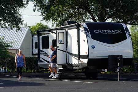 People look at an RV for sale at a dealership in Dover