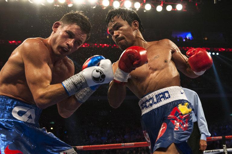 Manny Pacquiao (R) during his world welterweight championship boxing bout against Chris Algieri in Macau on November 23, 2014