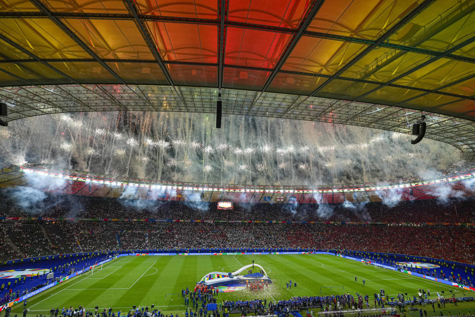 Pyrotechnics go off as Spanish players celebrate after they won the final match between Spain and England at the Euro 2024 soccer tournament in Berlin, Germany, Sunday, July 14, 2024. (AP Photo/Andreea Alexandru)