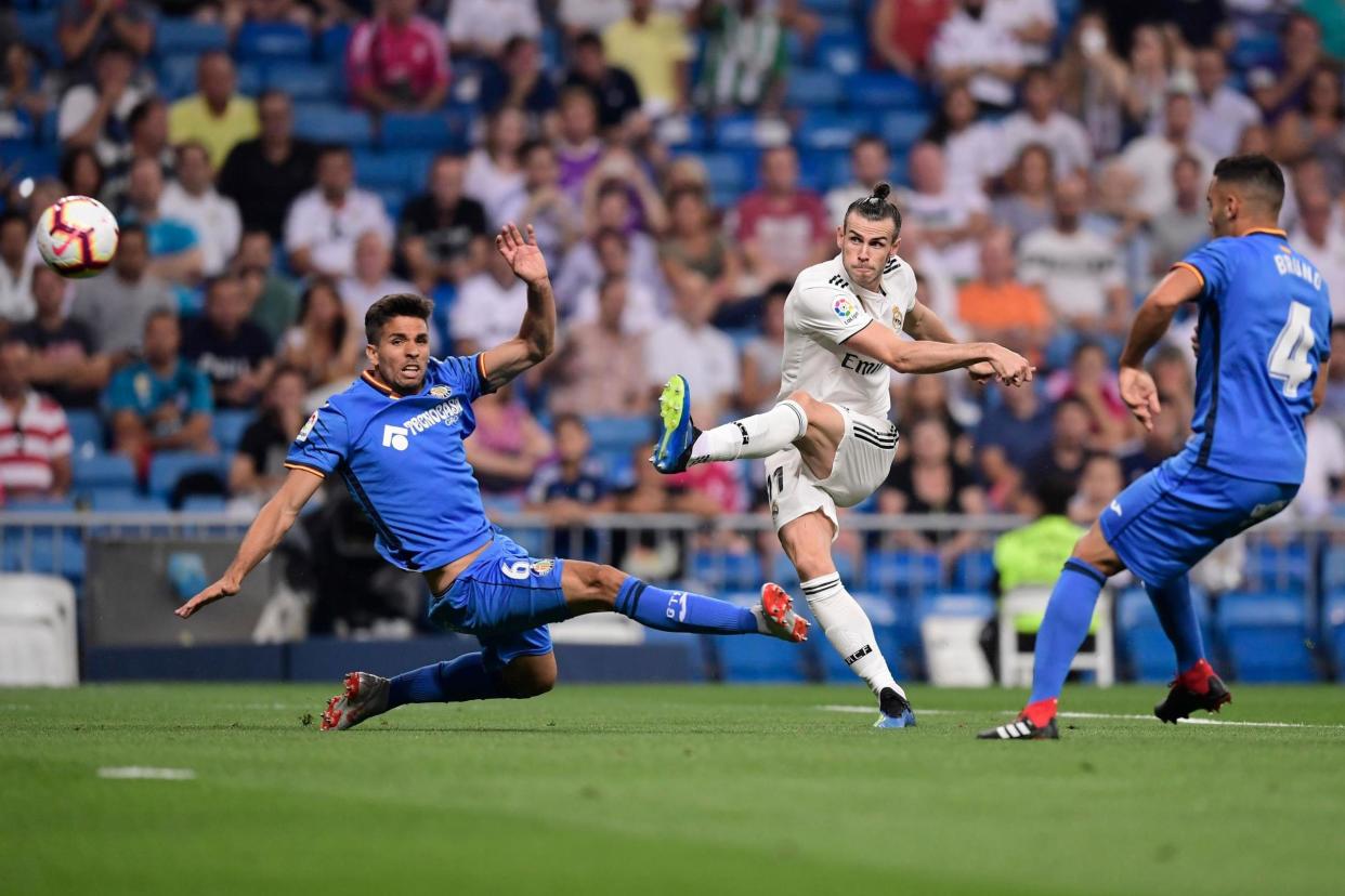 Empty seats: Bale curls an effort at goal during Real Madrid's La Liga opener: AFP/Getty Images