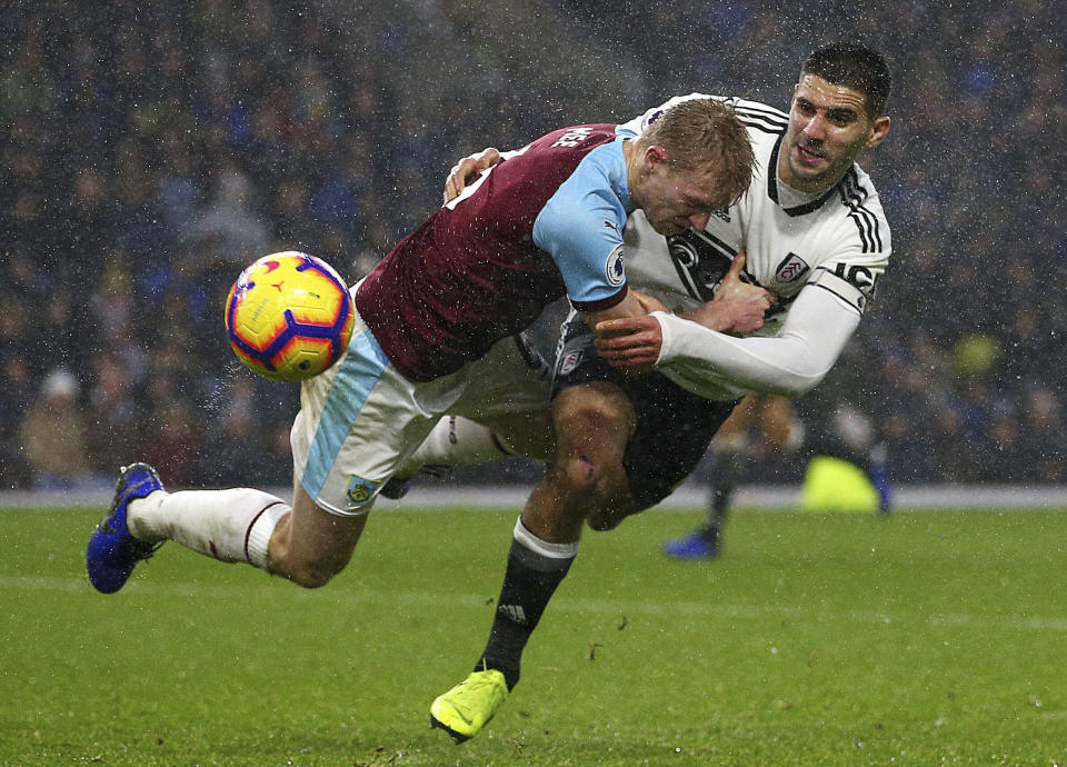 Fulham's Aleksandar Mitrovic, right, pulls back on Burnley's Ben Mee during the English Premier League soccer match between Burnley and Fulham at the Turf Moor stadium, Burnley, England. Saturday, Jan. 12, 2019. (Dave Thompson/PA via AP)