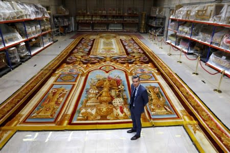 Herve Lemoine, head of the Mobilier National and the Gobelins Manufactury, poses in front of the 19th century choir carpet of Notre-Dame de Paris Cathedral in Paris