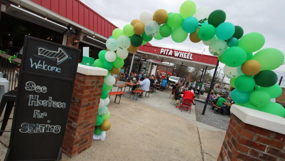 People gathered inside and outside at Pita Wheel during the St. Patrick’s Day Celebration Saturday afternoon, March 13, 2021.
