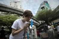 A woman prays at the reopened Erawan shrine in central Bangkok, on August 31, 2015