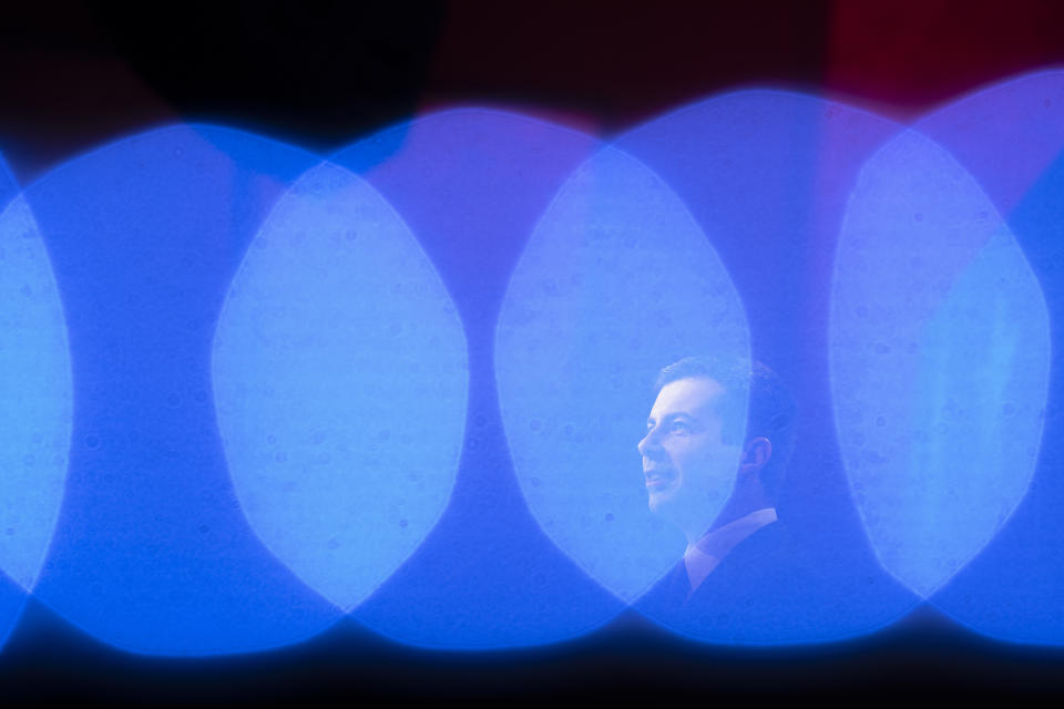 Democratic presidential candidate former South Bend, Ind., Mayor Pete Buttigieg, is framed by stage lights while speaking at the ​U.S. Conference of Mayors' Winter Meeting, Thursday, Jan. 23, 2020, in Washington. (AP Photo/Cliff Owen)