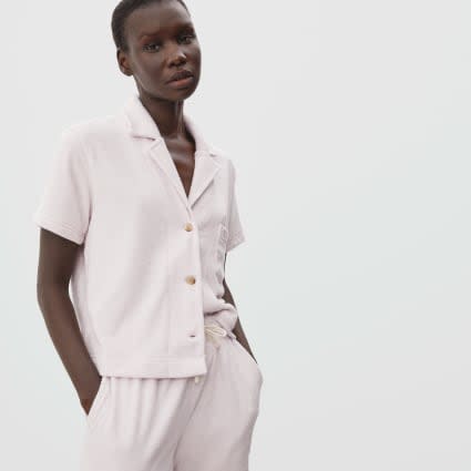 <h2>Everlane The Terry Cloth Notch Shirt</h2><br>For a top that embraces the very of-the-moment <a href="https://www.refinery29.com/en-us/2021/01/10259506/athflow-loungewear-trend" rel="nofollow noopener" target="_blank" data-ylk="slk:athflow loungewear trend" class="link rapid-noclick-resp">athflow loungewear trend</a>, consider gifting this easy button-down top made from a breathable blend of organic cotton and recycled terrycloth. <br><br><strong>Deal: </strong><a href="https://www.everlane.com/collections/womens-sale" rel="nofollow noopener" target="_blank" data-ylk="slk:Up to 65% off sale items" class="link rapid-noclick-resp">Up to 65% off sale items</a><br><strong>Promo Code: </strong>None<br><br><br><strong>Everlane</strong> The Terry Cloth Notch Shirt, $, available at <a href="https://go.skimresources.com/?id=30283X879131&url=https%3A%2F%2Fwww.everlane.com%2Fproducts%2Fwomens-terry-cloth-notch-shirt-orchid%3Fcollection%3Dwomens-sale" rel="nofollow noopener" target="_blank" data-ylk="slk:Everlane" class="link rapid-noclick-resp">Everlane</a>