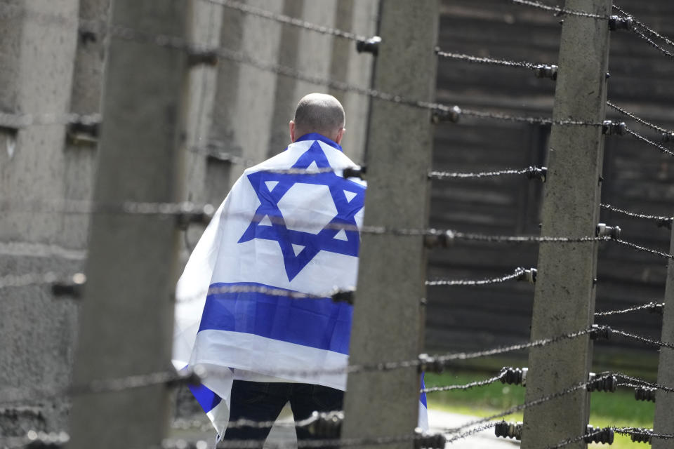 A man walks through the former Nazi German death camp of Auschwitz-Birkenau in Oswiecim, Poland, Monday, May 6, 2024 during the annual Holocaust remembrance event, the "March of the Living" in memory of the six million Holocaust victims. (AP Photo/Czarek Sokolowski)