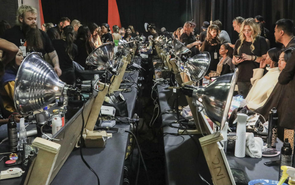 Stylist prepare models for the runway show unveiling the latest fashion creation from Brandon Maxwell, during New York Fashion Week, Saturday, Sept. 7, 2019, in the Brooklyn borough of New York. (AP Photo/Bebeto Matthews)