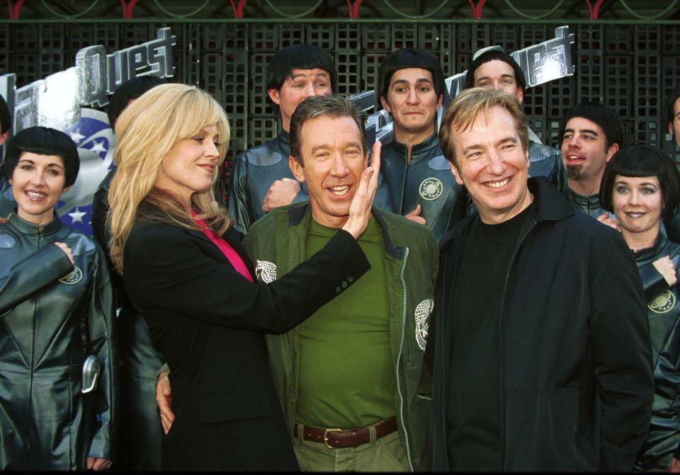 LOS ANGELES, UNITED STATES:  Characters from the movie "Galaxy Quest",  Sigourney Weaver (L), Tim Allen (C) and Alan Rickman (R), pose for the premiere of the science fiction, action comedy film outside  Mann's Chinese Theatre in Los Angeles.  AFP PHOTO/Jim RUYMEN (Photo credit should read JIM RUYMEN/AFP via Getty Images)