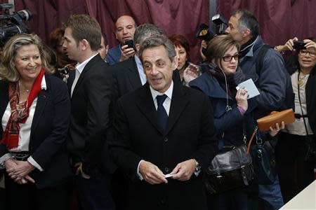 Former French President Nicolas Sarkozy prepares to cast his ballot at a polling station to vote in the first round in the French mayoral elections in Paris, March 23, 2014. REUTERS/Benoit Tessier