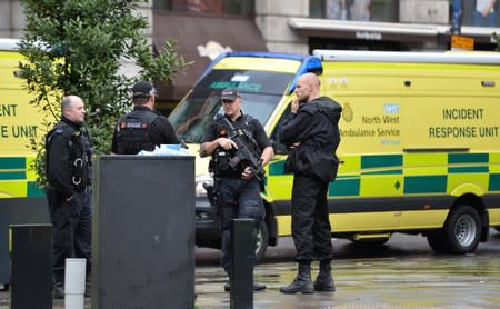 Police officers are seen outside the Arndale shopping centre after several people were stabbed in Manchester