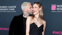 Adam Levine and Behati Prinsloo Share Red Carpet Kiss