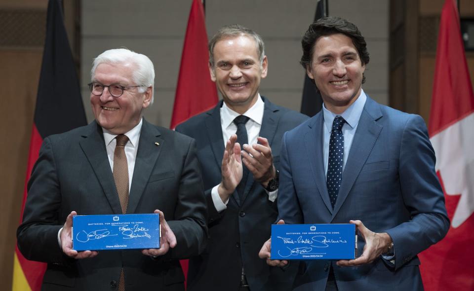 CEO of Volkswagen Group Oliver Blume looks on as Prime Minister Justin Trudeau and German President Frank-Walter Steinmeier hold up EV battery cells in Ottawa in April 2023. THE CANADIAN PRESS/Adrian Wyld