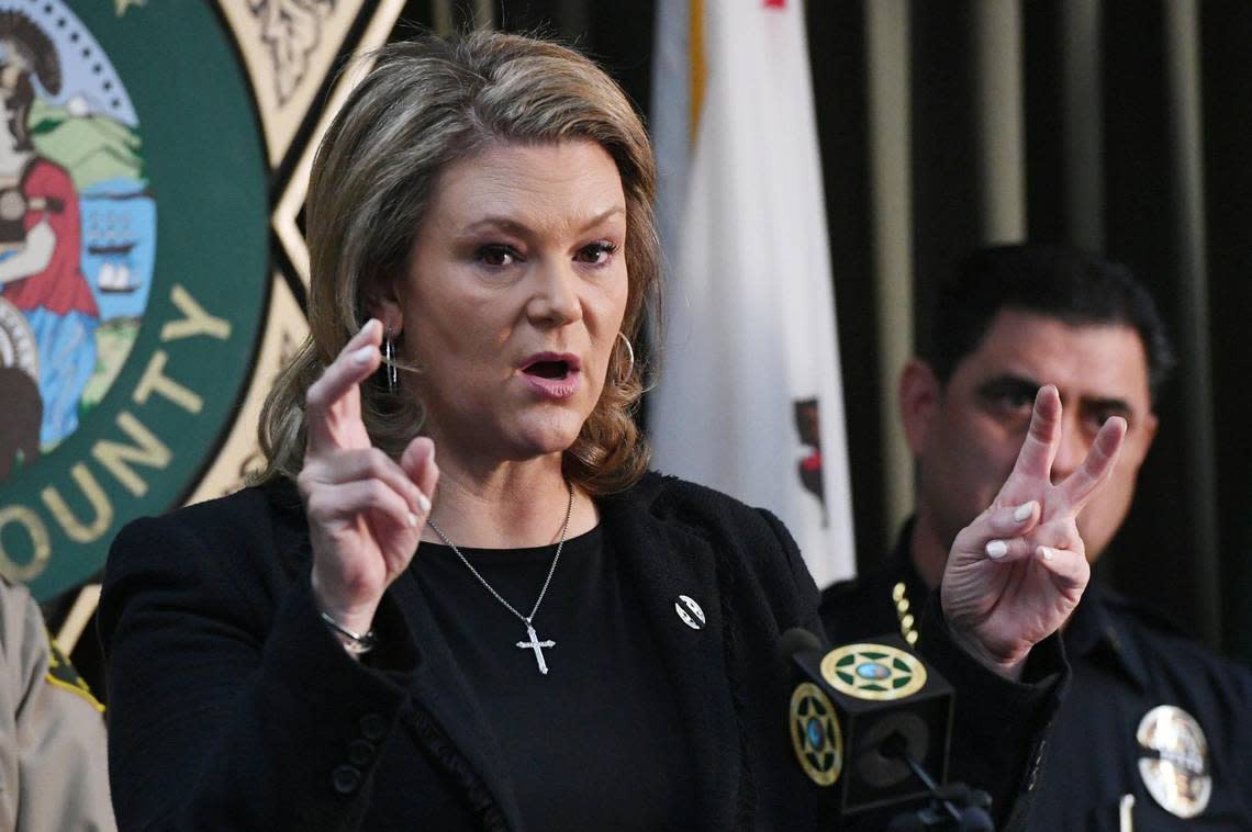 Fresno County District Attorney Lisa Smittcamp, with Selma Police Chief Rudy Alcaraz to the far right, releases an update on the killing of Selma police officer Gonzalo Carrasco Jr. at a press conference Friday, Feb 3, 2023 in Fresno.
