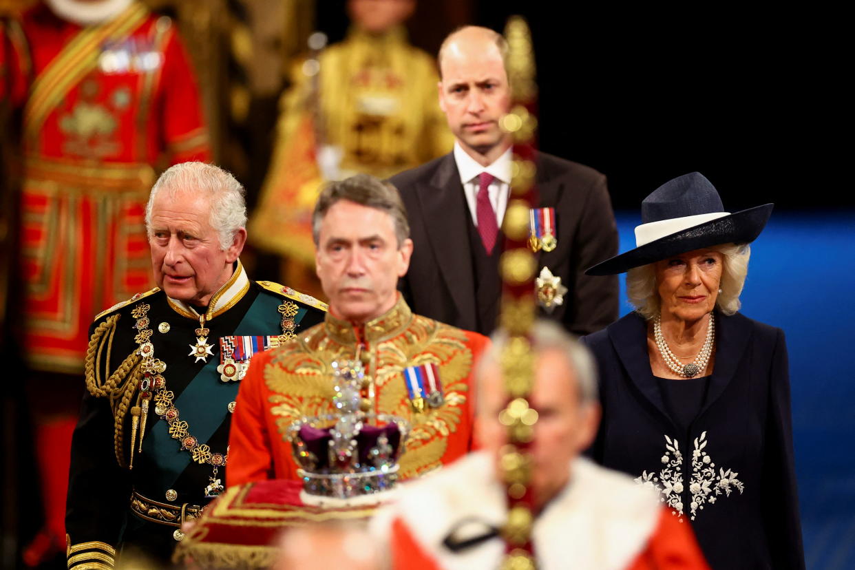 LONDON, ENGLAND - MAY 10: Prince Charles, Prince of Wales, Camilla, Duchess of Cornwall and Prince William proceed behind the Imperial State Crown through the Royal Gallery for the State Opening of Parliament in the House of Lords at the Palace of Westminster on May 10, 2022 in London, England. The State Opening of Parliament formally marks the beginning of the new session of Parliament. It includes Queen's Speech, prepared for her to read from the throne, by her government outlining its plans for new laws being brought forward in the coming parliamentary year. This year the speech will be read by the Prince of Wales as HM The Queen will miss the event due to ongoing mobility issues. (Photo by Hannah McKay - WPA Pool/Getty Images)