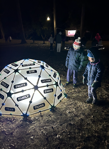 A couple of young visitors to the Community Lights The World exhibit at Buttonwood Park on Feb. 29 take in the "Unity Sculpture" art installation.