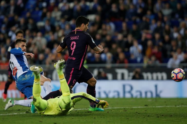 Barcelona's Luis Suarez (R) kicks to score during their Spanish league football match against Espanyol at the Cornella-El Prat stadium in Cornella de Llobregat on April 29, 2017