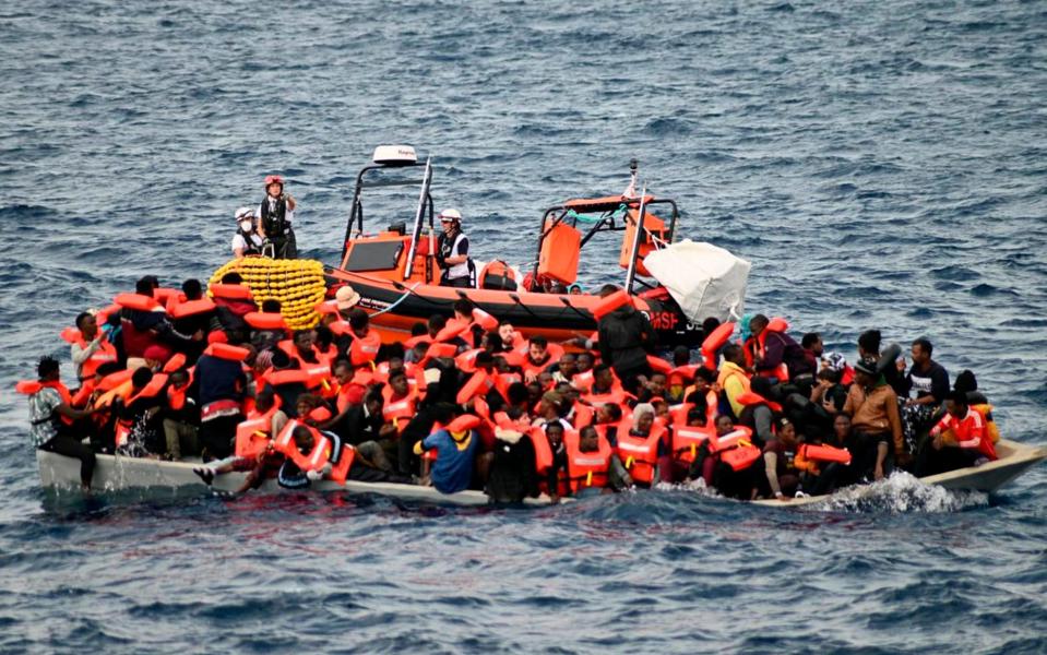 Overcrowded wooden boat packed with 99 migrants is approached by a tender from Doctors Without Borders off the Libya coast