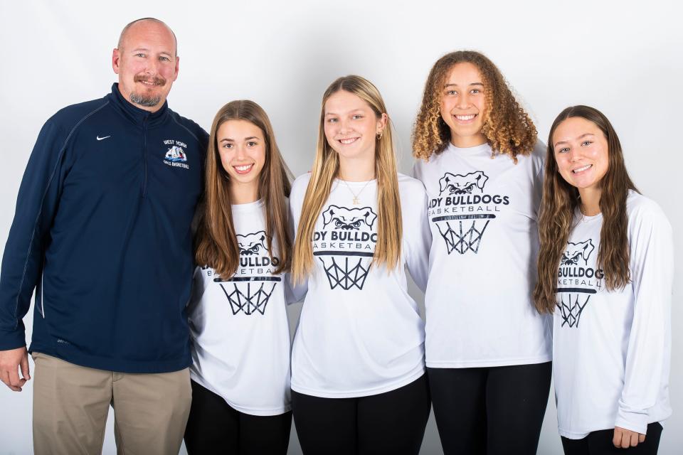 (From left) West York basketball head coach Jason Getz poses for a photo with players Lily Weaver, Kayla Laird, Faith Walker and Reagan Doll during YAIAA winter sports media days Wednesday, November 8, 2023, in York.