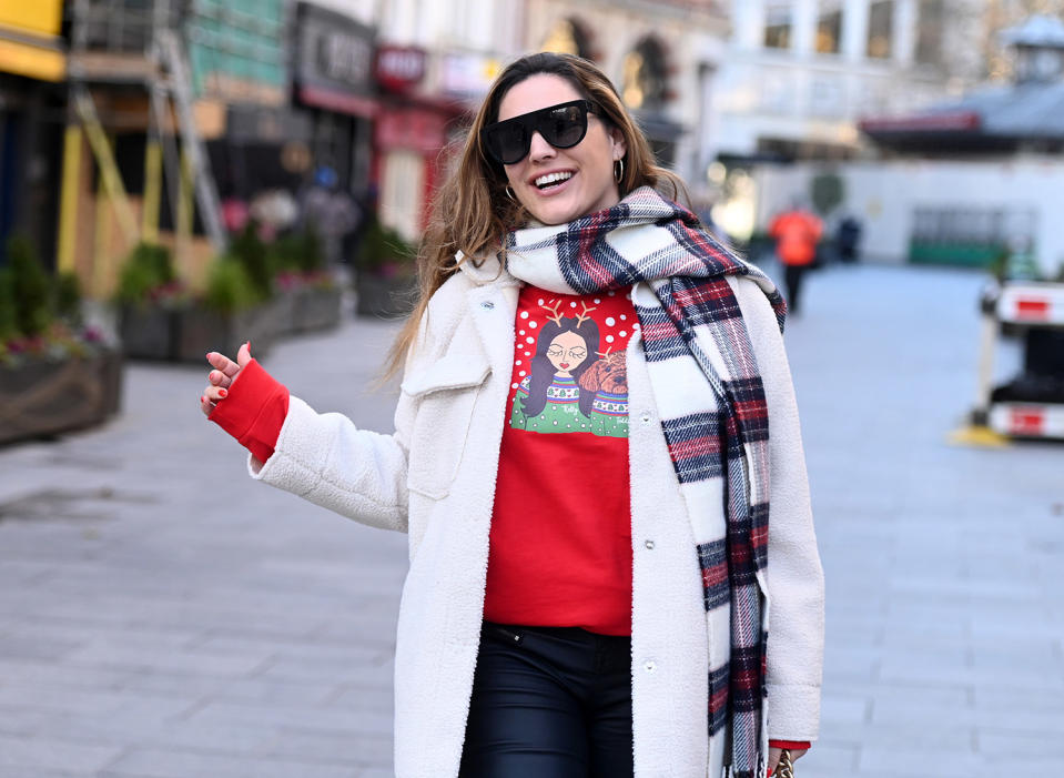 <p>Kelly Brook shows off her personalized Christmas sweater as she arrives at Global Radio studios in London to record her Heart FM show.</p>