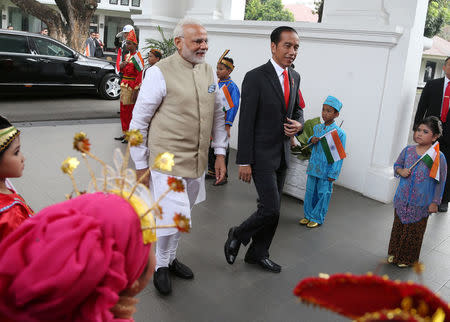 Indian Prime Minister Narendra Modi is greeted by Indonesian President Joko Widodo upon arrival at Merdeka Palace for their meeting in Jakarta, Indonesia May 30, 2018. REUTERS/Dita Alangkara/Pool