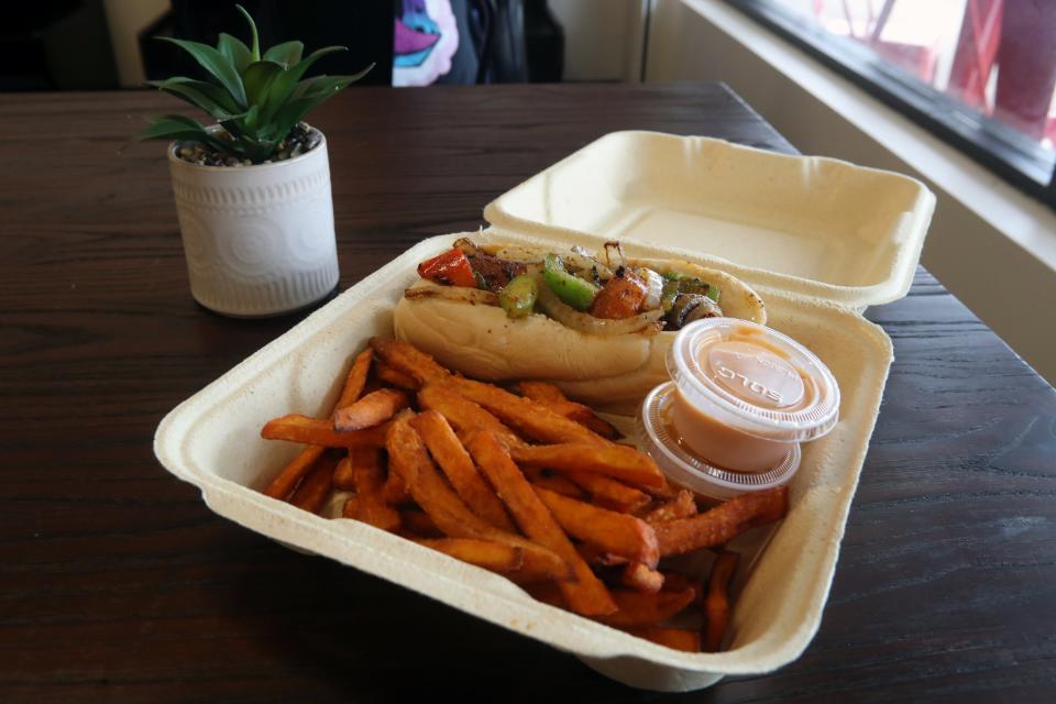 A spicy sausage hoagie with sweet potato fries is shown at Can't Believe It's Vegan during a soft opening for the restaurant July 8 in Westerville.