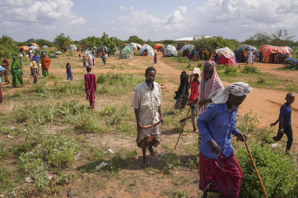 Internally displaced persons (IDPs) walk to receive a planned distribution of food, after El Niño rains damaged their houses in Mandera County, Kenya, Wednesday, Dec. 13, 2023. Rains began pounding the country in October. At the end of November Kenya President William Ruto convened an emergency cabinet meeting saying 38 of Kenya’s 47 counties had been affected by floods and mudslides made worse by the El Niño phenomenon. (AP Photo/Brian Inganga)