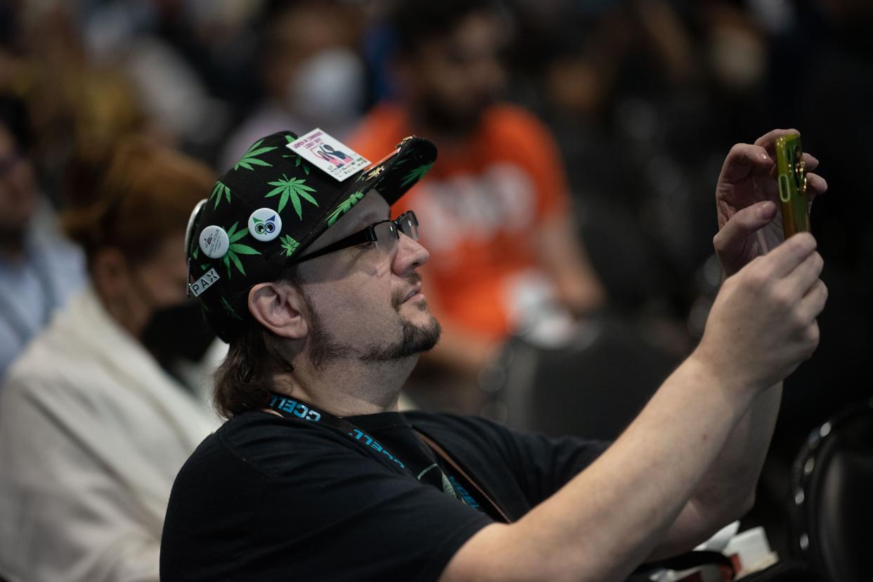 A guest takes a photo during the Cannabis World Congress and Business Exposition at the Javits Center on Friday, June 3, 2022. 