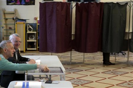 A voter stands in the voting booth in a voting station in Paris, March 23, 2014. REUTERS/Philippe Wojazer