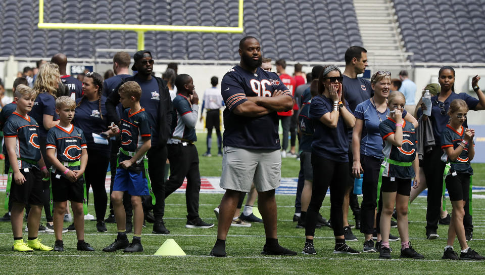 NFL Player Akiem Hicks of the Chicago Bears coaches a young team during the final tournament for the UK's NFL Flag Championship, featuring qualifying teams from around the country, at the Tottenham Hotspur Stadium in London, Wednesday, July 3, 2019. The new stadium will host its first two NFL London Games later this year when the Chicago Bears face the Oakland Raiders and the Carolina Panthers take on the Tampa Bay Buccaneers. (AP Photo/Frank Augstein)