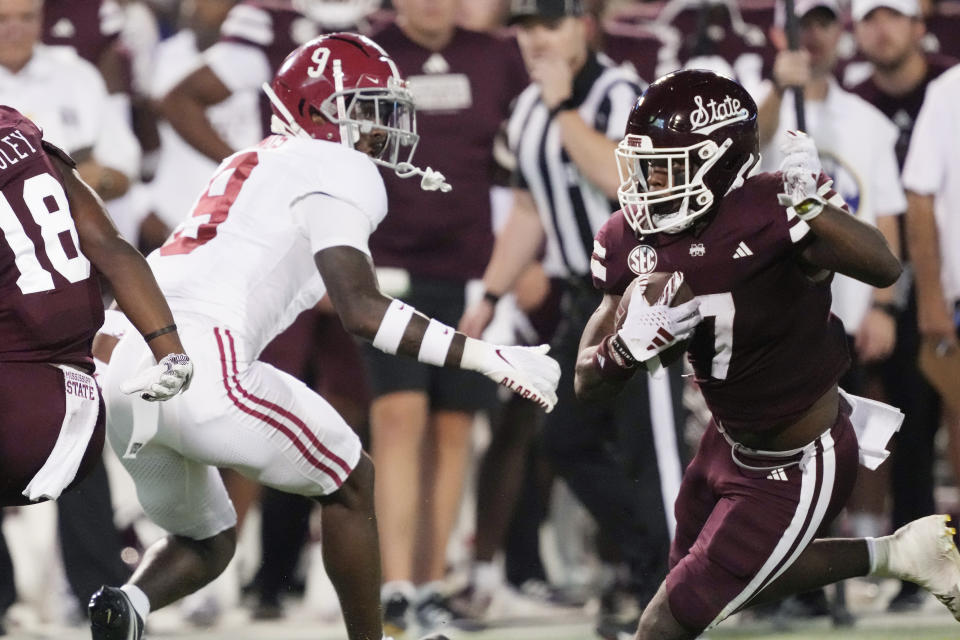 Mississippi State running back Jo'Quavious Marks (7) runs past Alabama defensive back Trey Amos (9) during the first half of an NCAA college football game, Saturday, Sept. 30, 2023, in Starkville, Miss. (AP Photo/Rogelio V. Solis)