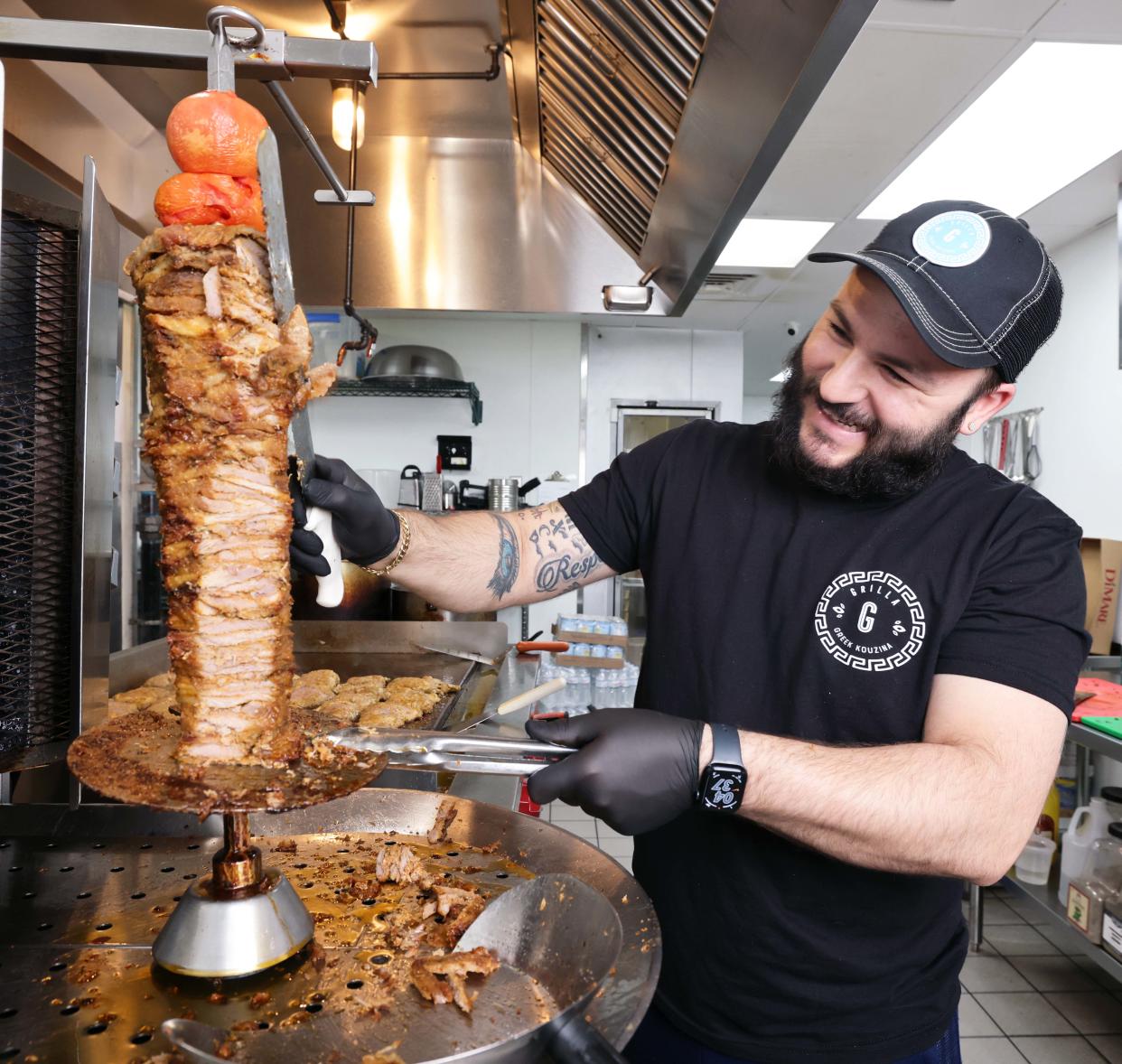 George Tambasidis, owner of Grilla Greek Kouzina on Broadway in Taunton, slices a fabulous cone of pork for a gyro (or "turn") on Wednesday, April 3, 2024.