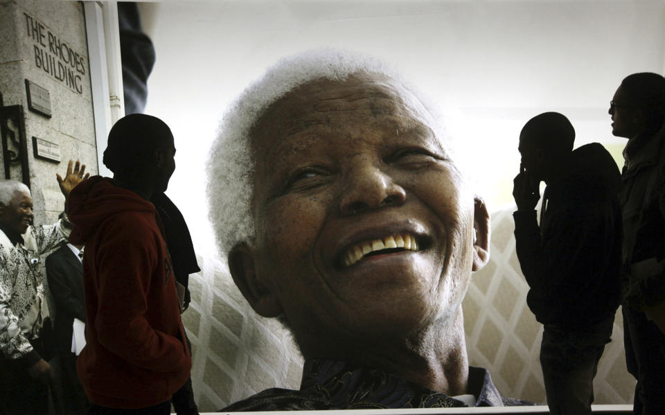 FILE - Giant photographs of former South African President Nelson Mandela are displayed at the Nelson Mandela Legacy Exhibition at the Civic Centre in Cape Town, South Africa, on June 27, 2013. The planned auction of dozens of artifacts belonging to Nelson Mandela has been suspended pending a court application to completely halt it, the body that protects South Africa's cultural heritage said Tuesday, Jan. 30, 2024. (AP Photo, File)