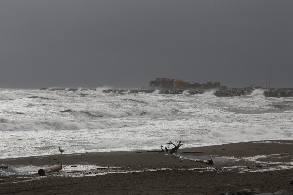 FILE - Waves from the Bering Sea splash up on a jetty on Sept. 16, 2022, in Nome, Alaska. Much of the Arctic is in a burst of freak December 2022 warming. Scientists say some of it is random weather from storms and some of it is from low sea ice. The low sea ice is due to climate change. (AP Photo/Peggy Fagerstrom, File)