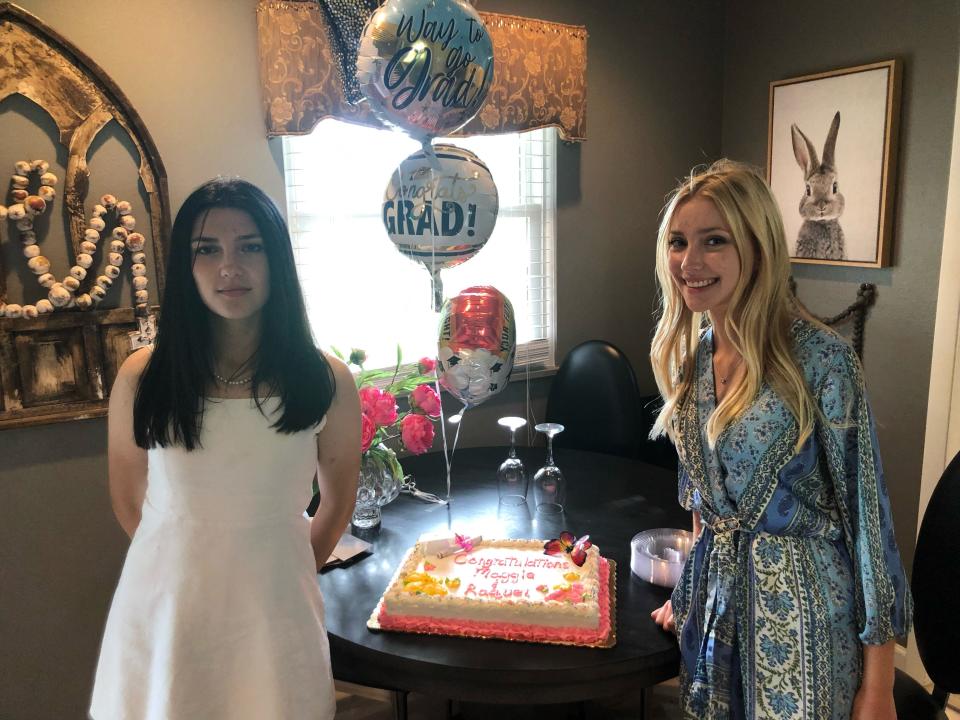 Raquel Gonzalez, left, of Spain and Margherita Montina of Italy are pictured at their high school graduation open house. Dina Pelham of Adrian hosted the two exchange students last year.