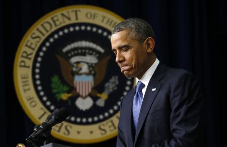 U.S. President Barack Obama pauses while speaking at the White House Youth Summit on the Affordable Care Act in Washington December 4, 2013. REUTERS/Kevin Lamarque